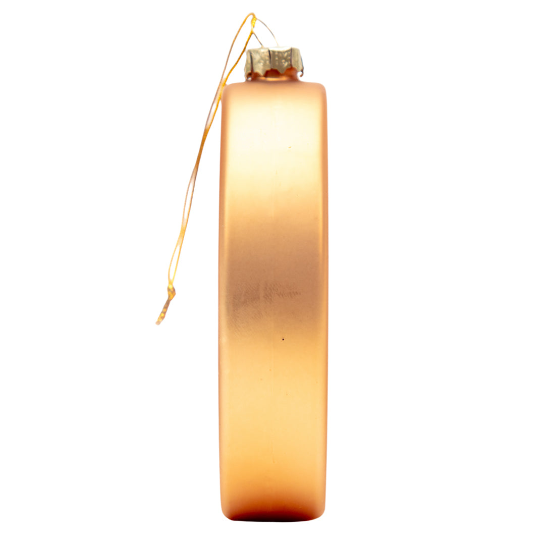 Side profile of the gold oval glass ornament showing its smooth hand-blown shape and gold hanging cord.