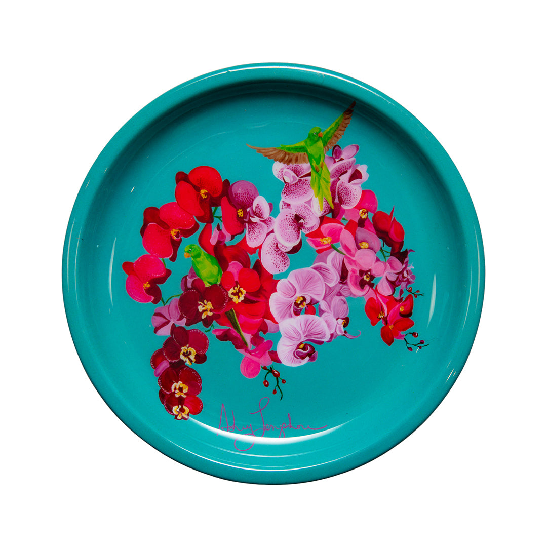 Turquoise plate with pink and red floral design on a white background