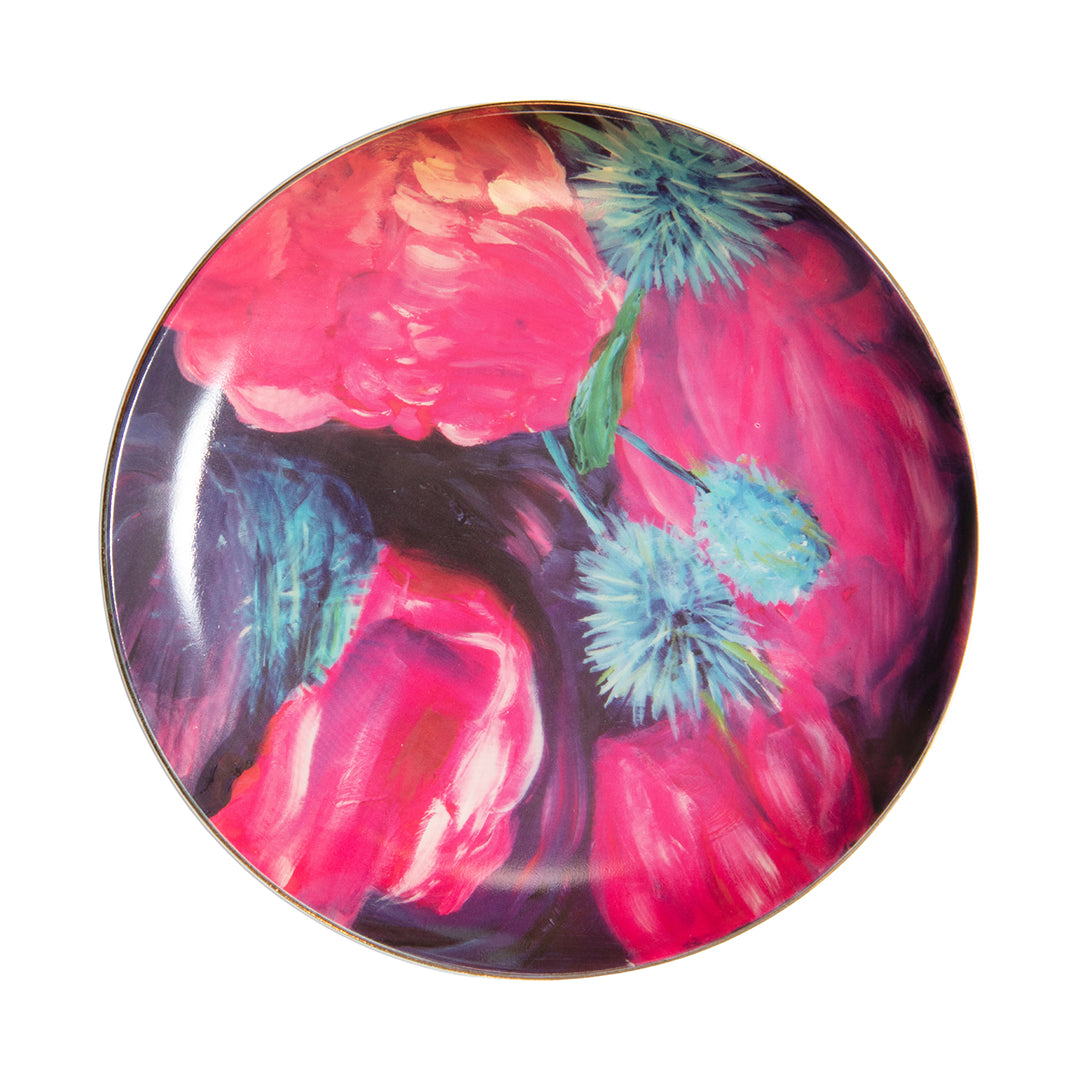 Porcelain dessert plate with large pink and blue floral artwork and gold rim.
