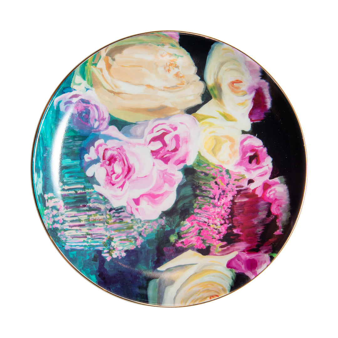 Porcelain dessert plate featuring abstract floral artwork in pinks, purples, and creams with a gold rim.
