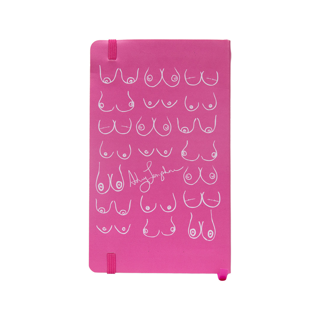 Back of hot pink journal with white line-art bust illustrations and Ashley Longshore’s signature at the bottom.