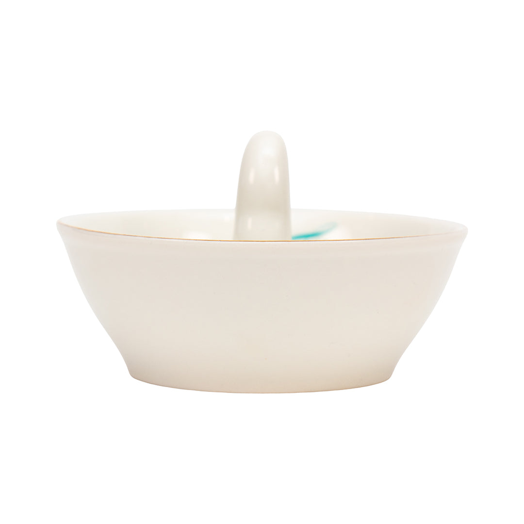 Ashley Longshore porcelain middle finger ring dish with red nail and turquoise script text reading “Give Um the Finger” along with Ashley Longshore’s signature.
