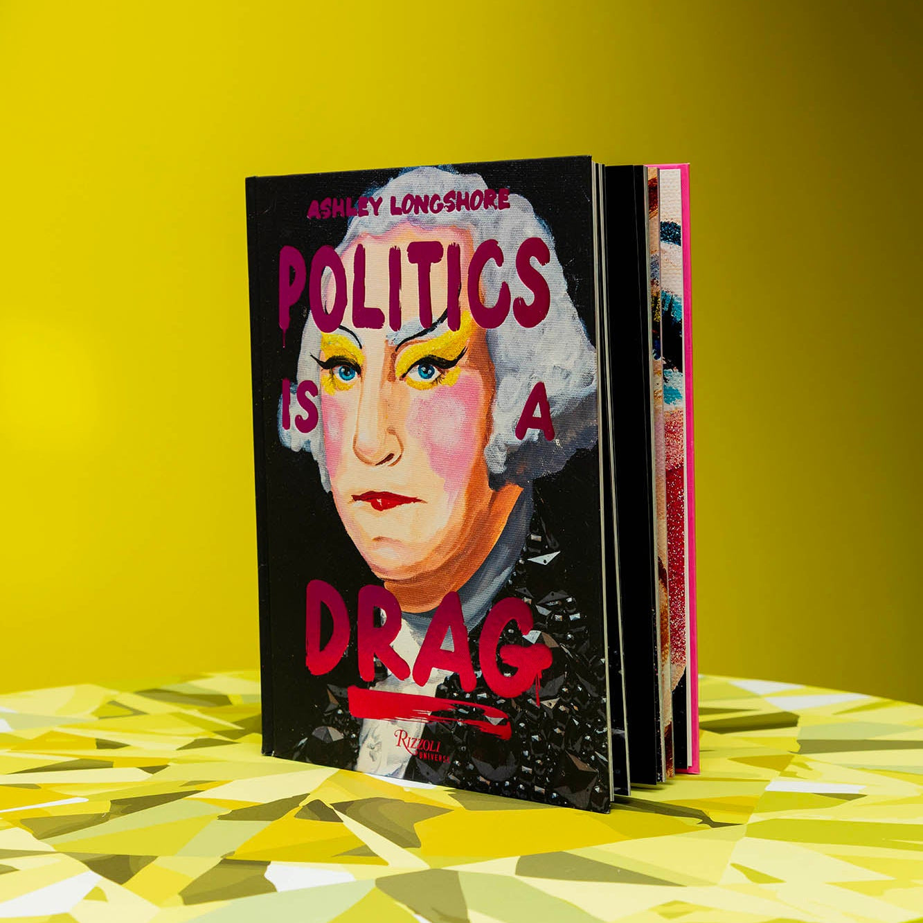Book titled 'Politics is a Drag' on a yellow surface