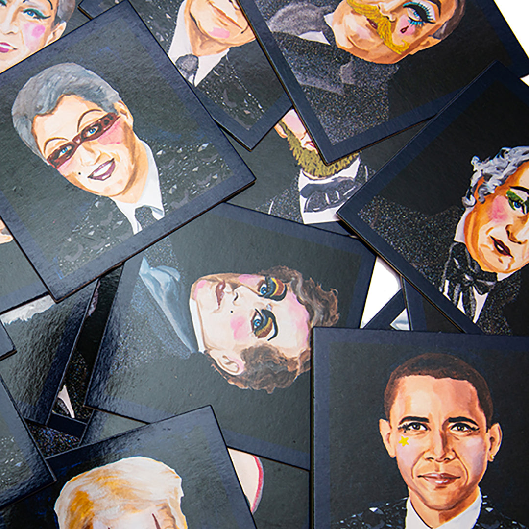 Open Politics Are a Drag memory game box showing pairs of glossy cards with Ashley Longshore’s vibrant portraits of U.S. presidents in full drag glam.